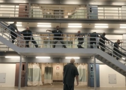 Prisoners perform along a stairway in the prison