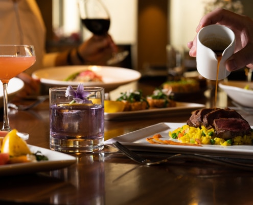 A table filled with brunch delights and cocktails.