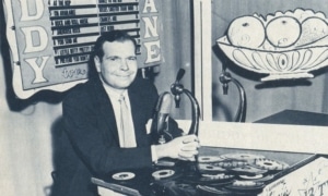 Buddy Deane sits at his turntable