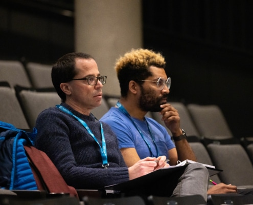 Playwright Andrew Rosendorf sits with director Chip Miller during rehearsal. They are deeply invested in what's happening onstage.