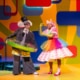 Gerald the elephant and Piggie stand onstage, wearing fun accessories like a pool inner tube, a rainbow tutu, and a top hat.