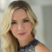 Headshot of actress Noelia Antweiler with wavy blonde hair and a sleeveless black and white shirt