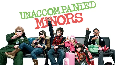 Movie poster for 'Unaccompanied Minors' showing six children sitting on airport seats with luggage around them, all wearing sunglasses and striking playful poses