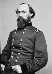 A black and white portrait of Union Major General Gordon Granger. He is un uniform that a long beard and mustache and looking at the camera.