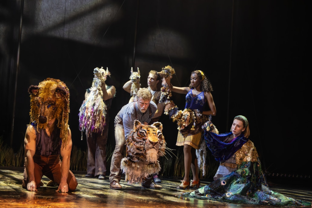 A group of puppeteers are shown with the animals that they make come to life on stage in Water for Elephants: tiger, bear, llamas and a bird.