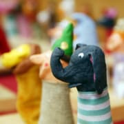 Variety of colorful finger puppets representing an elephant, monkey, and clown.