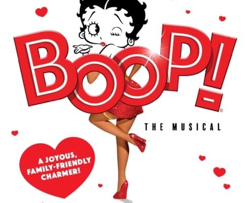 A graphic showing a stylized cartoon figure in a red sparkly dress posing behind large red letters spelling ‘BOOP! The Musical' with hearts scattered around and a heart-shaped caption reading ‘A joyous, family-friendly charmer!