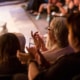 Audience clapping with performer on stage