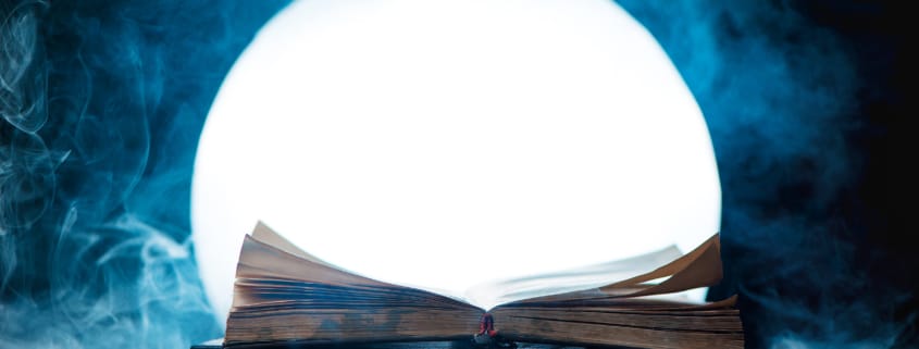 An open book of spells in full Moon. Reader imagination and writing inspiration concept with copy space