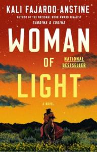 Book cover for Woman of Light by Kali Fajardo-Anstine. Large cream-colored title text appears over an orange and gold sunset sky with scattered clouds. In the foreground, a figure on horseback rides through a grassy landscape toward distant mountains. The cover includes the author's name at the top and a “National Bestseller” designation.
