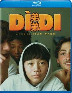 Movie cover for Dìdi, a film by Sean Wang. Four teenagers are gathered closely together, with a person in a gray hoodie centered in the foreground. Large orange title text appears above the group.
